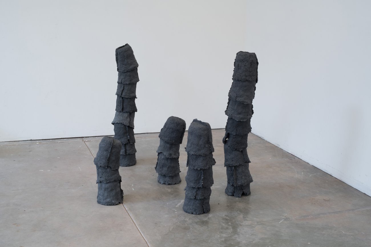 Image of installation of The Growth Obsession. Image shows 5 stacks of paper pulp molded vessels.