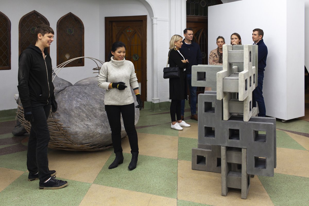 Exhibition visitors playing with cement blocks