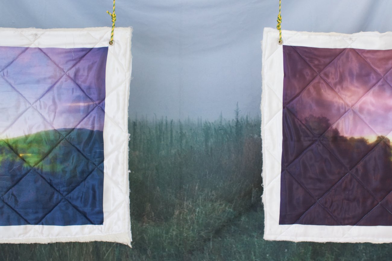 Close-up of two quilts in front of a blanket