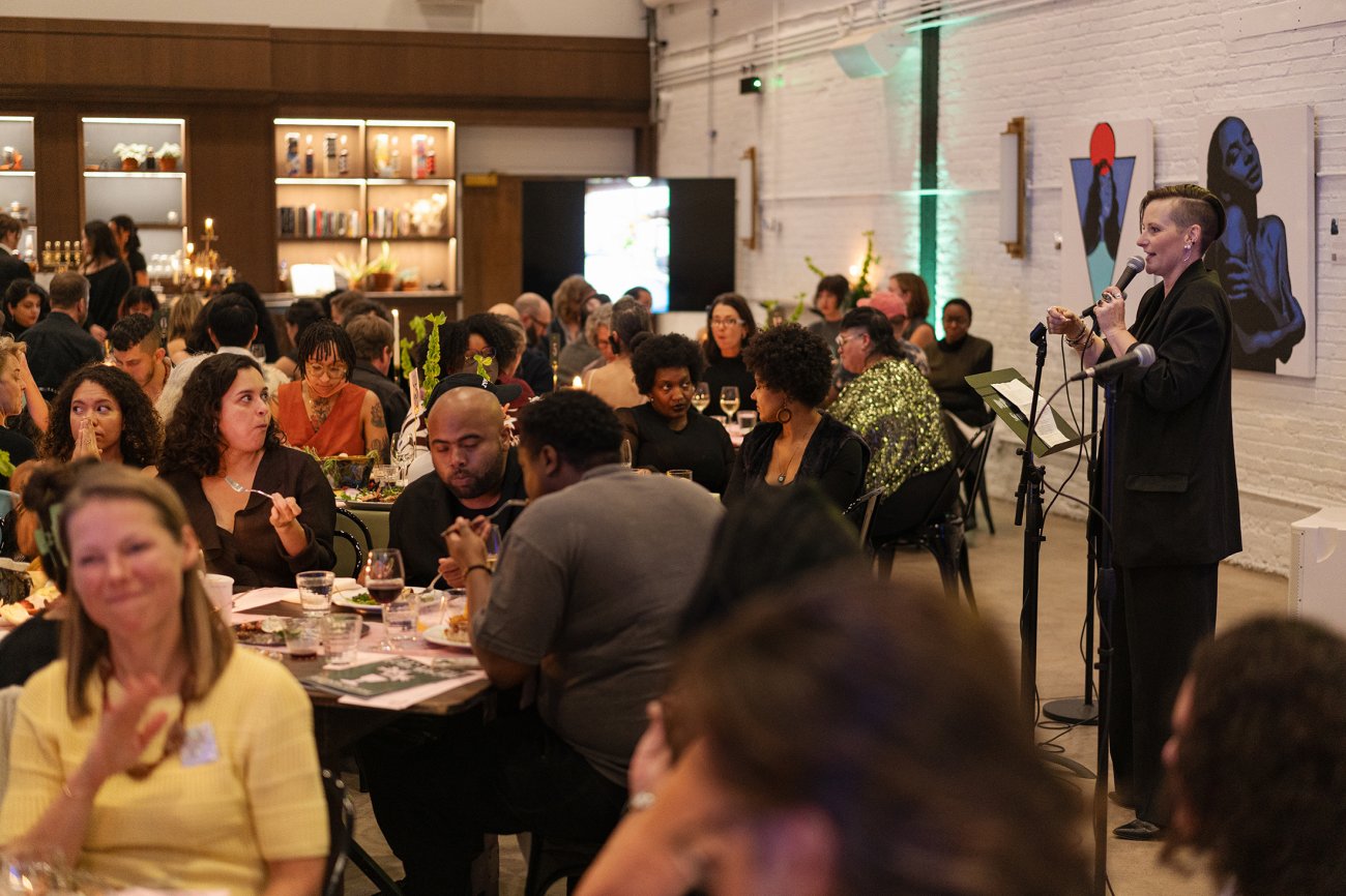 PErson at microphone speaking to room of people