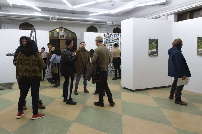 People gather in gallery at opening reception
