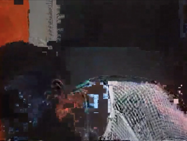 Pixelated image with what appears to be a black body in a white mesh shirt bending over in the foreground.